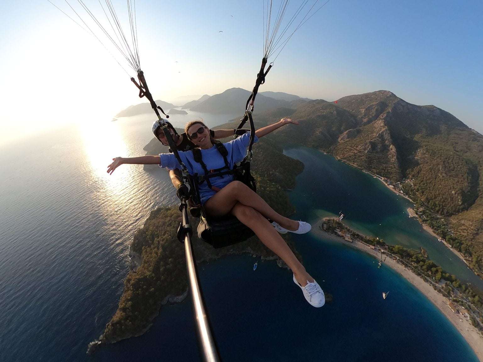 A group of paragliders high-fiving after a successful tandem flight